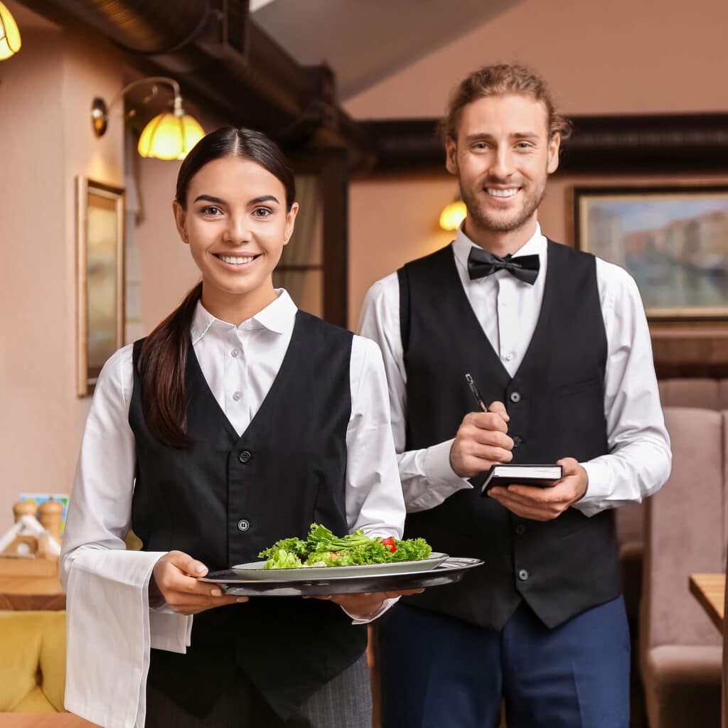 Portrait of young waiters in restaurant