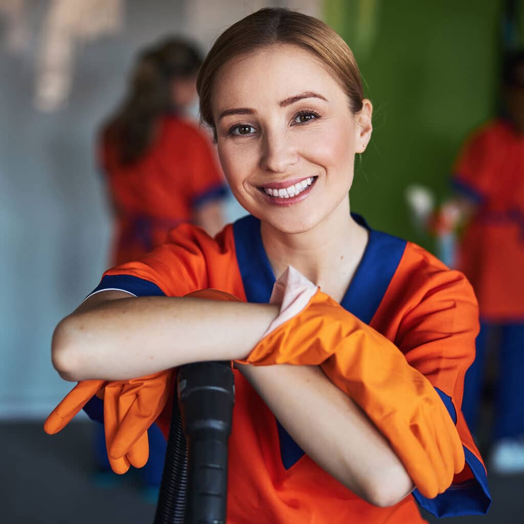 Pleased female janitor posing for the camera at work